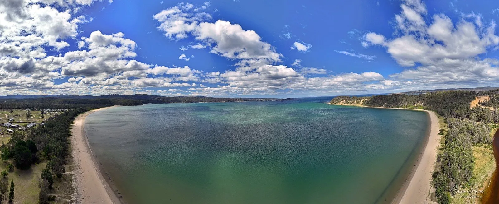 A 180 degree panorama of the long beach curving round Twofold Bay near Boydtown